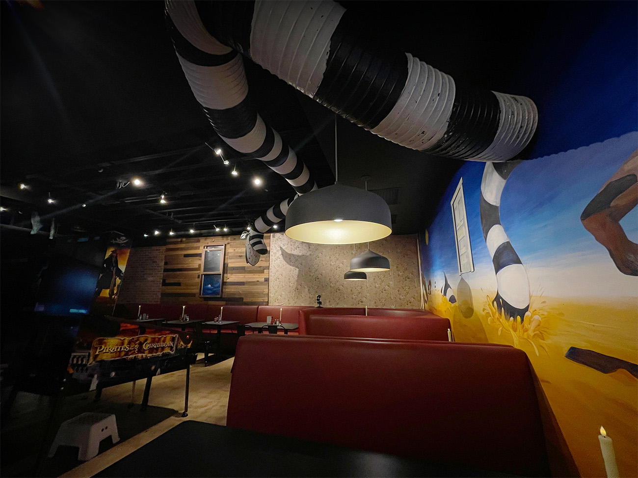 people having fun eating and playing pinball at the diner